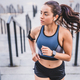 Attractive slim female runner jogging on the stairs in sporty outfit in  urban area Stock Photo by insidecreativehouse