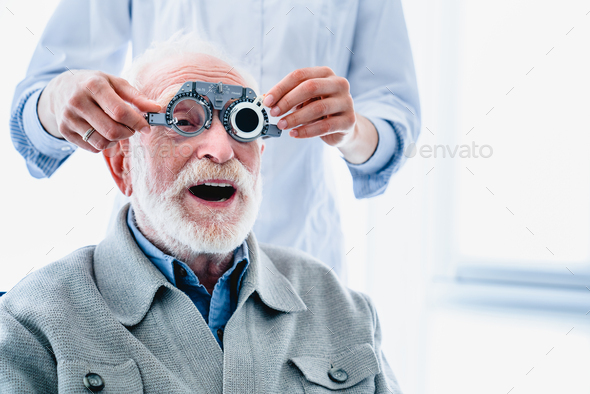 Enthusiastic elderly male patient wearing ophthalmic glasses for vision check