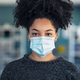 Young beautiful afro woman putting on an hygienic mask to prevent others from a virus - PhotoDune Item for Sale