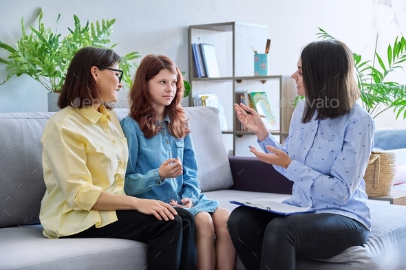 Mother and preteen daughter in individual therapy with child psychologist in office