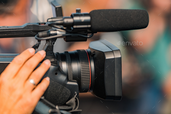 Live streaming. Camera at a Press Conference. Stock Photo by microgen