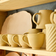 Part of display consisting of shelves with handmade earthenware in shop - PhotoDune Item for Sale
