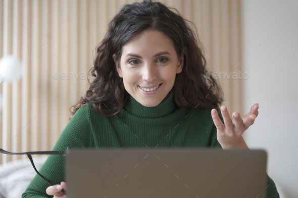 Smiling young Italian woman teacher tutor talks with students during online lesson on laptop
