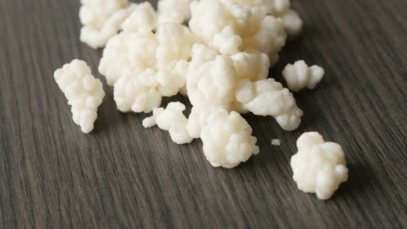 Slow tilt over milk kefir drink fungus grains bacterial fermentation starter 4K 2160p 30fps UltraHD  alt