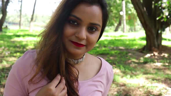 Beautiful Indian woman smiling and looking at the camera alt