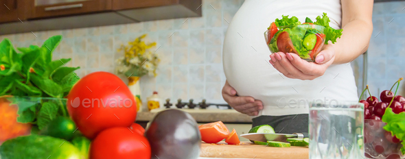 A pregnant woman eats vegetables and fruits. Selective focus. Stock ...