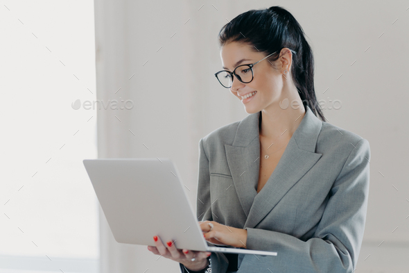 Self confident cheerful woman economist analyzes report about company income