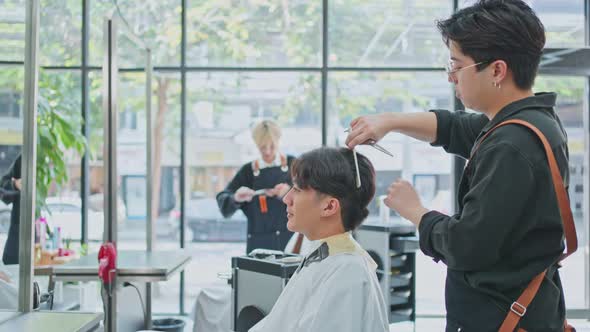 Asian professional hairdresser team giving a beauty salon service and treatment to young customers. alt