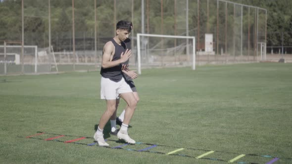 Personal trainer giving motivation to football player. training for running alt