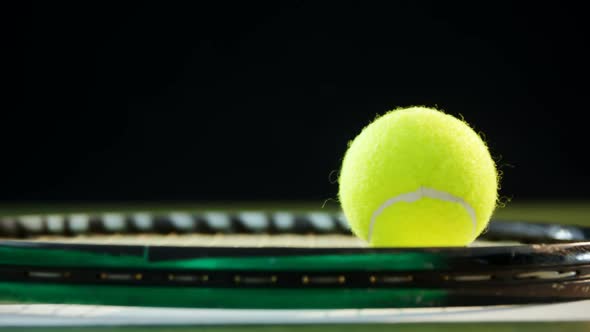 Tennis ball on racket in court alt