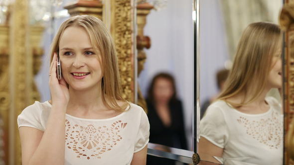 Attractive stylish woman using a mobile phone alt