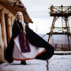 Beautiful blonde Viking dressed in a black cloak against the backdrop of the castle - PhotoDune Item for Sale