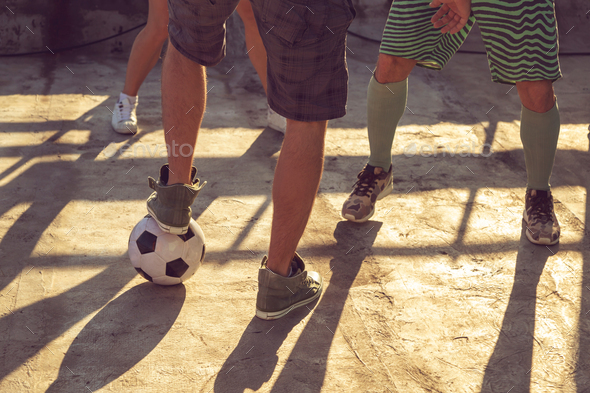 Detail of friends playing football