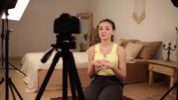 A Young Beautiful Girl Blogger Records a Video for Her Channel