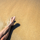 Long slim young woman legs relaxing lying down and sunbathing on sand  tropical beach under hot sun Stock Photo by bilanol