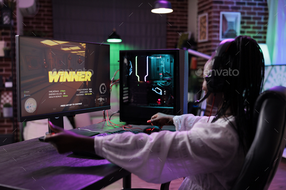 Young woman winning online video games tournament play