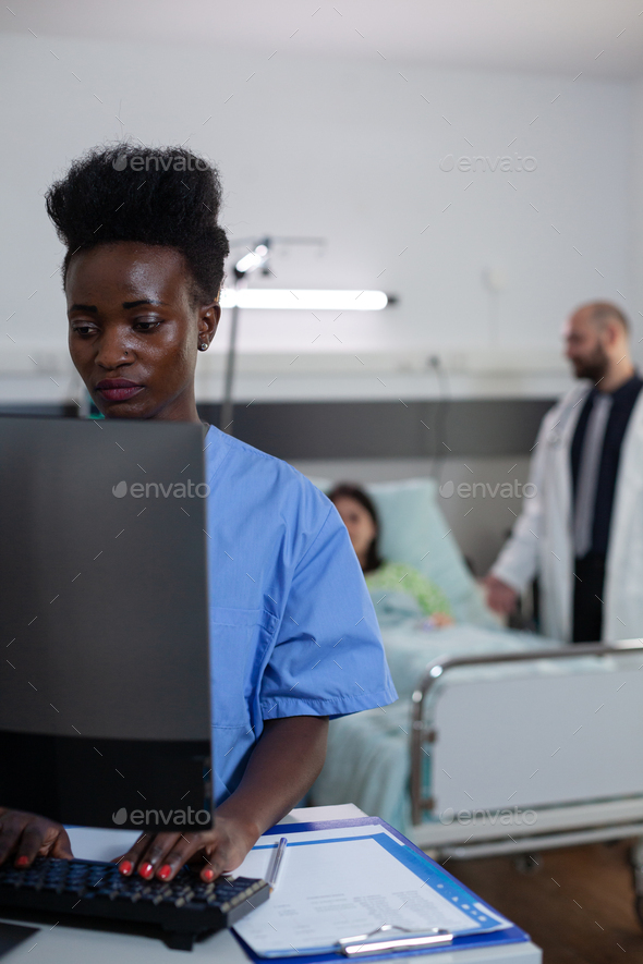 Portrait of african american health care worker using personal computer for reading lab results