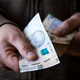 White man giving Ukrainian money bills closeup - PhotoDune Item for Sale