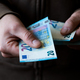 White man giving Euro paper money twenty bills closeup - PhotoDune Item for Sale