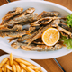 Dish Of Georgian National Cuisine: Mullet Fish With orange and french fries. fish and chips - PhotoDune Item for Sale