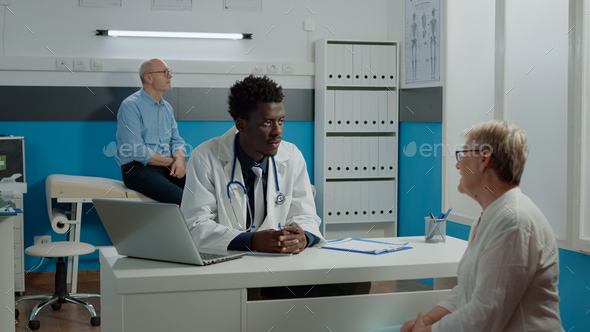 Medic of african american ethnicity doing examination Stock Photo by DC ...