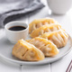 Chinese dumplings and soy sauce on plate. - PhotoDune Item for Sale