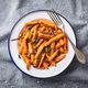 Roasted baby carrots with salt and rosemary on plate. - PhotoDune Item for Sale