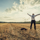 Successful businessman standing victoriously in the middle of field - PhotoDune Item for Sale