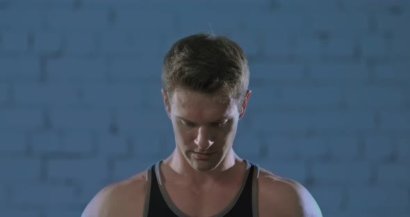 Young Male Athlete Raises a Serious Look and Purposefully Looks alt