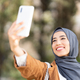 Muslim woman taking a selfie in a park - PhotoDune Item for Sale