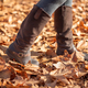 Boots of a woman walking through fallen leaves in autumn - PhotoDune Item for Sale