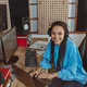 Beautiful woman sound engineer, radio presenter, smiles at camera while working - PhotoDune Item for Sale