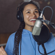 Beautiful African singer-actress recording a new song or voicing lyrics, rehearsing in a soundproof - PhotoDune Item for Sale