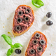 Aromatic and homemade bruschetta with black olives for breakfast. - PhotoDune Item for Sale