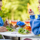 Young man and woman eating healthy food, spending summer time together outdoors - PhotoDune Item for Sale