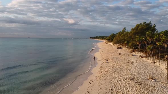 Drone Slowly Approaching Man Fishing On Shore Line OnTropical Island alt