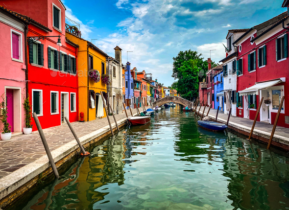 Boats and colorful painted houses in a canal of Burano island, Venice, Italy - Stock Photo - Images