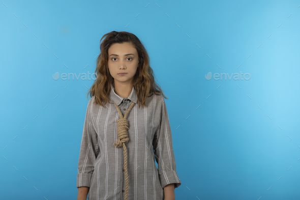 A stressed young adult hang a rope around her neck and looking at camera
