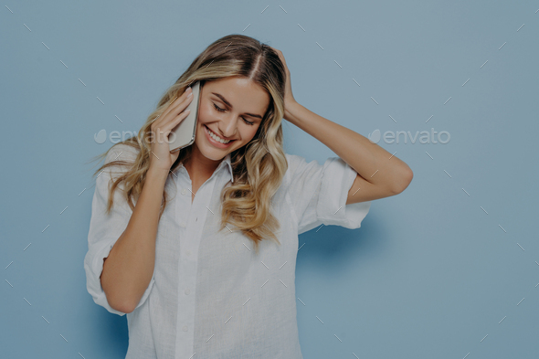 Attractive Young Blonde Girl Talking On Mobile Phone Smiling Tenderly