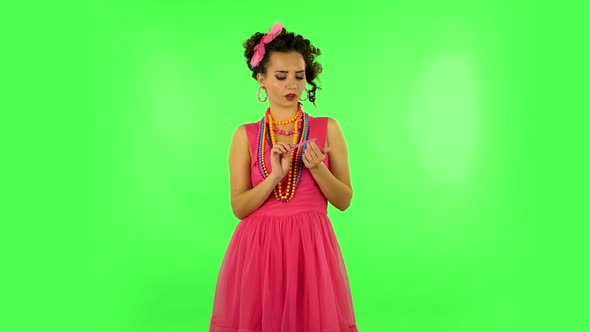 Girl Makes Herself Manicure with Pink Nail File on Green Screen at Studio alt