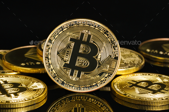 Golden coins with bitcoin symbol on black blackground