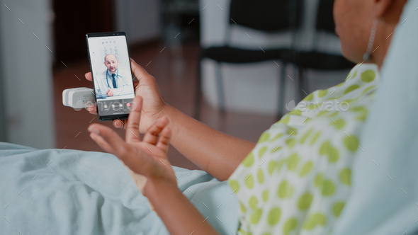 Close up of patient holding smartphone with video call