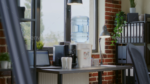 Close up of water dispenser and coffee machine on table for people working in office