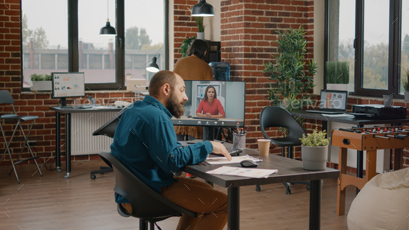 Business man doing video call meeting with woman on computer