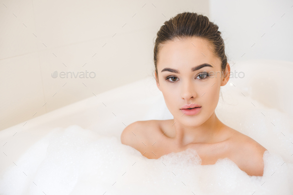 Portrait Of Attractive Young Woman Taking Bath With Foam At Home Stock