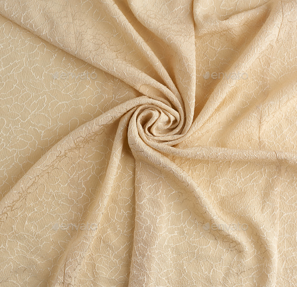 Beige satin textile fabric with embroidery elements, piece of canvas for sewing curtains