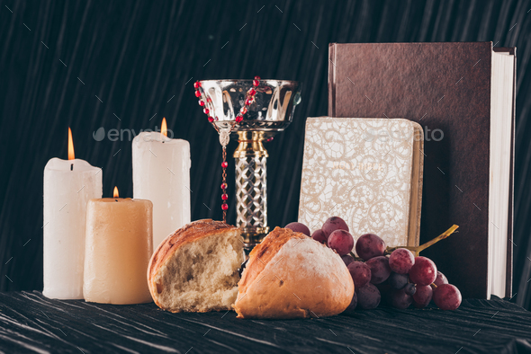 candles, chalice, holy bible, bread and grapes for Holy Communion