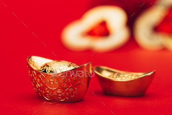 close-up shot of chinese golden ingots on red surface