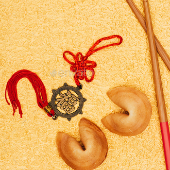 top view of chinese talisman and fortune cookies on golden surface, Chinese New Year concept