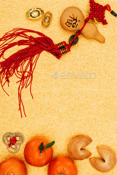 top view of traditional chinese talisman with tangerines and fortune cookies on golden surface,